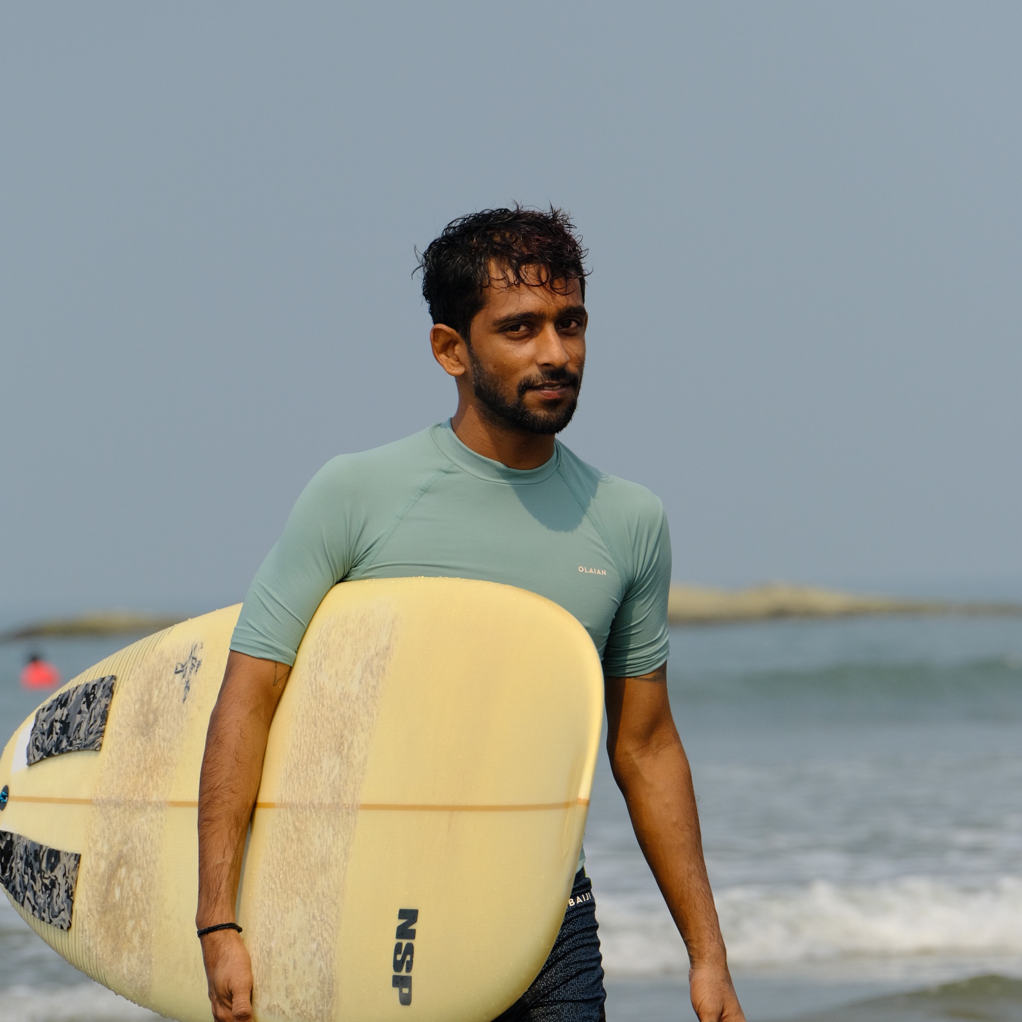 Portrait of Vrujen with a surfboard